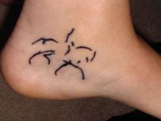 a person with a tattoo on their foot that has birds flying around it and the word love written in black ink