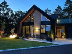 a modern house lit up at night in the evening