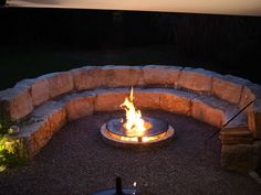 an outdoor fire pit lit up at night