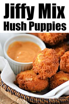 a basket filled with fried hush puppies next to dipping sauce