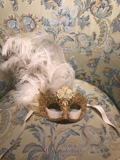 "This mask with feathers belongs to our collection of masks \"Lady Plumes\". The fetaher masks are the most elegant, refine and stunning masks of our collections. This mask is a traditional and original papier-mache Venetian mask, handmade and decorated in our Atelier in Venice using Burano Lace,gold leaf, Swarovski, feathers, different trimming. It is perfect for any masquerade party, Halloween costume, pro or event in Venice or elsewhere during Carnival. This mask can be gently bent to form to Floral Mask Masquerade Ball, Masquerade Makeup Ideas, Masquerade Party Aesthetic, Masquerade Mask Aesthetic, Venice Mask Carnival, Masquerade Fashion, Burano Lace, Gold Masquerade Mask, Masquerade Prom