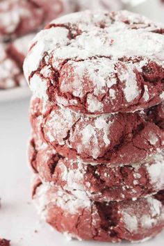 red velvet crinkle cookies stacked on top of each other with powdered sugar