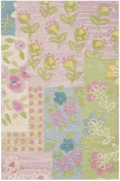 a colorful rug with flowers and leaves on the side in pink, green, blue, yellow