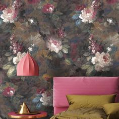 a floral wallpaper with pink, white and green flowers on the walls next to a bed