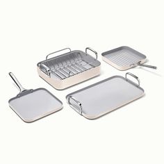 three pans and one tray with spatulas on them are shown in this image