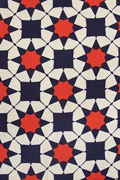 a red, white and black pattern with stars on it