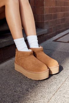 This is one of our most precious styles, and boy, do we have the viral-status receipts to prove it. This ultra, elevated Classic boot is a must-have combination of newness and nostalgia. It's made with rich suede and lined inside with our UGGplush™ wool blend for signature softness. The outsole of this product is either a sugarcane EVA outsole, which is a responsible compound using sugarcane foam that allows us to reduce dependency on fossil fuels by replacing petroleum-based ethylene, or a Trea Ugg Micro Mini Platform, Ugg Platform Ultra Mini, Ugg Ultra Mini Platform, Winter Uggs, Shoes Wishlist, Cute Uggs, New Uggs, Ugg Ultra Mini, Winter Footwear