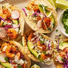 shrimp tacos with avocado, cilantro, and lime wedges