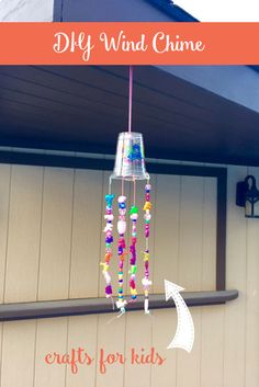 a wind chime hanging from the side of a house with text overlay that reads diy wind chime crafts for kids