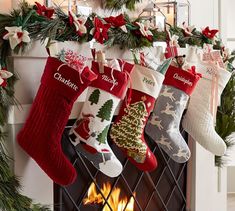 christmas stockings hanging from a mantel over a fireplace