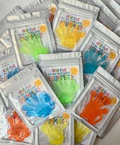 many different colored handprints in plastic bags