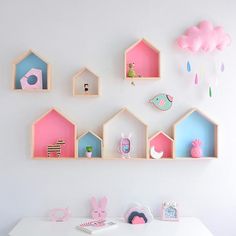 a white table topped with pink and blue shelves