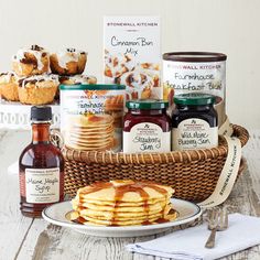 a basket filled with lots of food next to some condiments and sauces