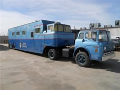 a large blue truck parked in a parking lot