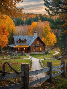 a log cabin surrounded by trees with fall foliage in the foreground and a path leading to it