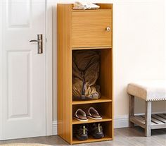 a wooden shoe rack with shoes on it next to a door