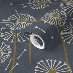 a blue and gold wallpaper with dandelions printed on it's surface