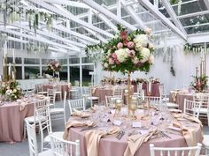 the tables are set up with pink and white linens for an elegant wedding reception