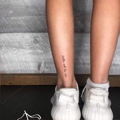 a woman's legs with the word love tattooed on her lower leg and foot