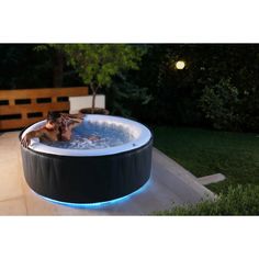 an inflatable hot tub is lit up with blue lights on the outside and inside