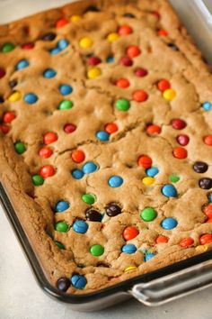 a cookie with m and m on it in a pan