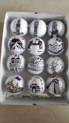 six golf balls with different designs in a box