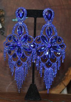 "These fun and stylish rhinestone extra long earrings are a great statement piece! You will stand out with these oversized wide royal blue earrings! Pageant, photo shoots or stage! Size of earrings: 2.5\" Wide and a stunning 6\" Long. Color: Royal Blue Base Metal: Silver Clip on available! Just select \"clip on\" under style Please note these earrings are oversized earrings. Clip on option available More colors available! Just send us a message! Looking for a matching bracelet? check out our bra Blue Glamorous Crystal Earrings For Evening, Glamorous Blue Chandelier Earrings For Party, Glamorous Blue Crystal Earrings For Party, Glamorous Blue Crystal Earrings For Evening, Royal Blue Jewelry, Blue Diamond Earrings, Royal Blue Earrings, Extra Long Earrings, Pageant Earrings