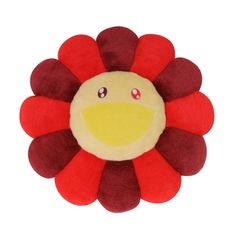 a red and yellow flower with eyes on it's face, sitting in front of a white background