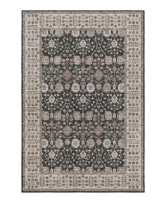 a rug with an intricate design on the front and back side, in grey tones