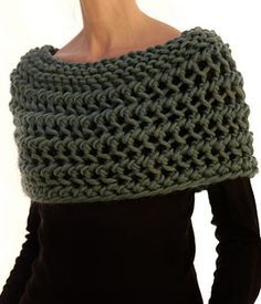 a woman wearing a green knitted scarf