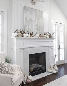 a living room filled with furniture and a fire place in front of a painting on the wall