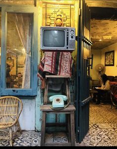 an old fashioned phone sitting on top of a shelf