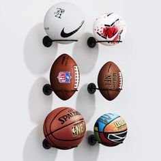 four basketballs mounted to the side of a wall