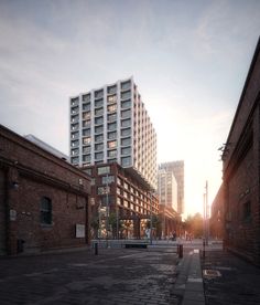 an empty city street with tall buildings in the background