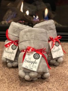 two gray stuffed animals sitting next to each other on top of a carpeted floor