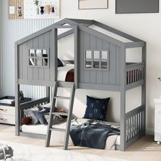 a child's bedroom with a loft bed and bunk beds in grey, white and blue colors