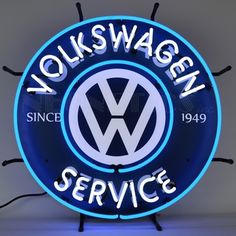 the volkswagen service neon sign is lit up and ready to be hung on the wall