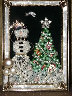 a snowman and a christmas tree made out of beads in a frame with pearls