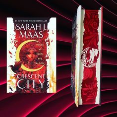 two books are sitting next to each other on a red and black background with swirls