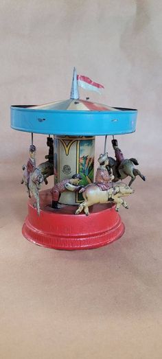 an old fashioned carousel with horses on it