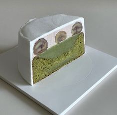 a piece of cake that is sitting on a white plate and has green frosting