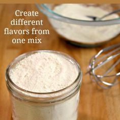 there is a small glass jar filled with flour next to a whisk on a wooden table