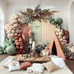 a room filled with lots of different types of balloons and decorations on the wall, including a teepee tent