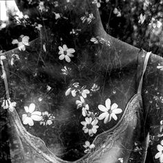 black and white photograph of an open bra with flowers all over it's back