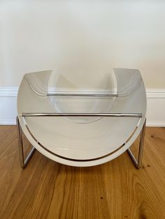 a white plate sitting on top of a wooden floor