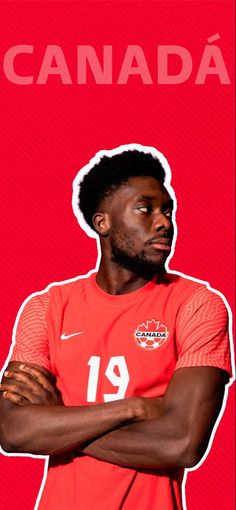 a man standing with his arms crossed in front of a red background that says canada