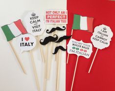 there are some fake moustaches on top of toothpicks that say i love italy