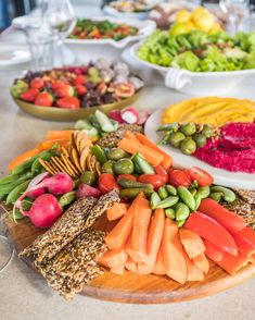 an assortment of vegetables and fruits on a platter