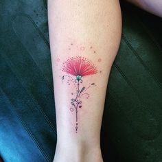 a woman's foot with a flower tattoo on the side of her left leg