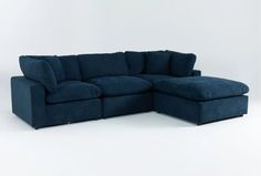 a large blue sectional sofa sitting on top of a white floor